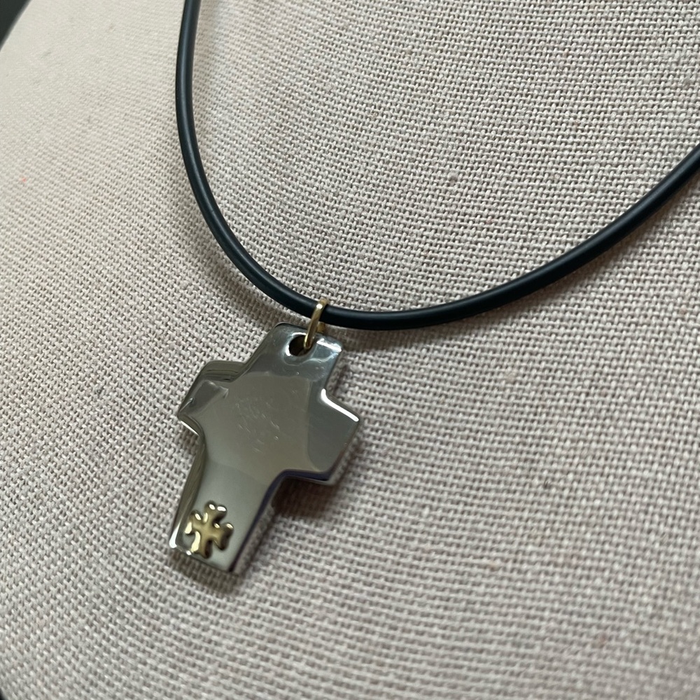 Stainless steel cross on black rubber cord